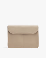 Laptop bag with flap front on a plain background