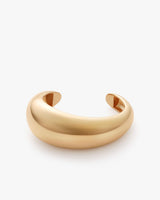 Open cuff bracelet on a plain background.
