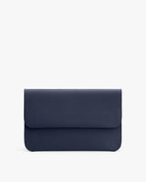A textured clutch bag with a flap closure against a plain background.