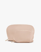 Two cosmetic bags with zippers on a plain background.