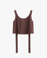 Sleeveless cropped top with overhanging long back straps.