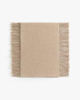 Rectangular scarf with fringed edges.