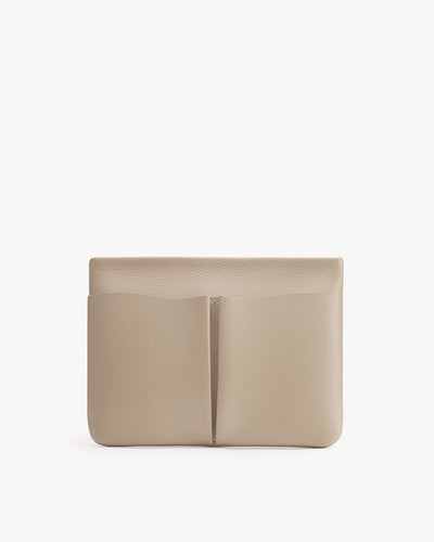 Rectangular clutch with a central seam and exterior pockets.