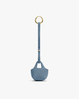 Small textured bag with long strap and metal ring attachment.