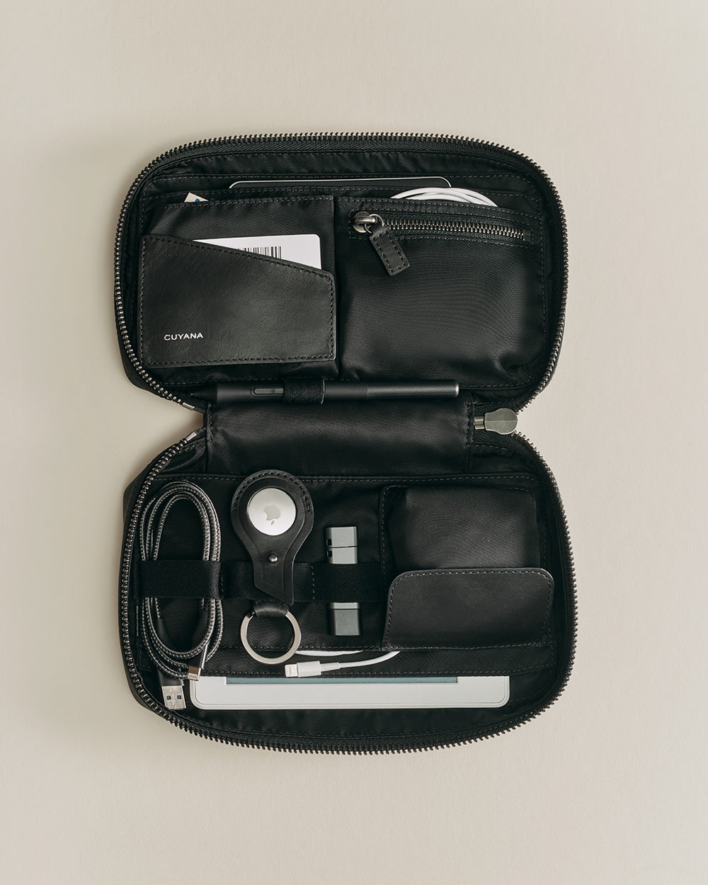 Organizer case with various personal items and tech accessories.