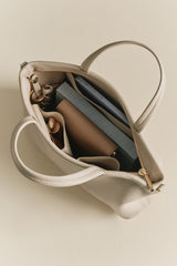 Open handbag with visible contents including a wallet and keys.