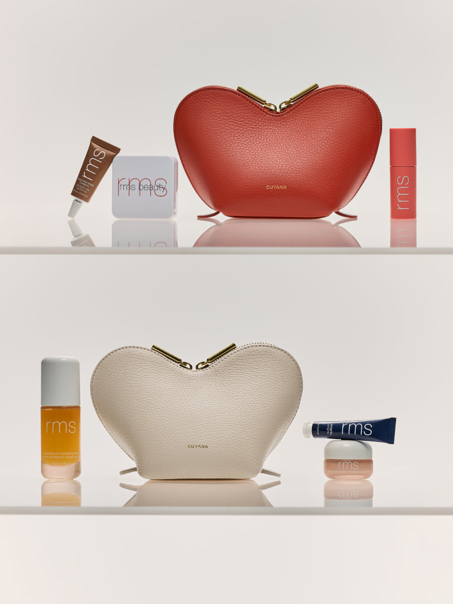 Two pouches with beauty products displayed around them.