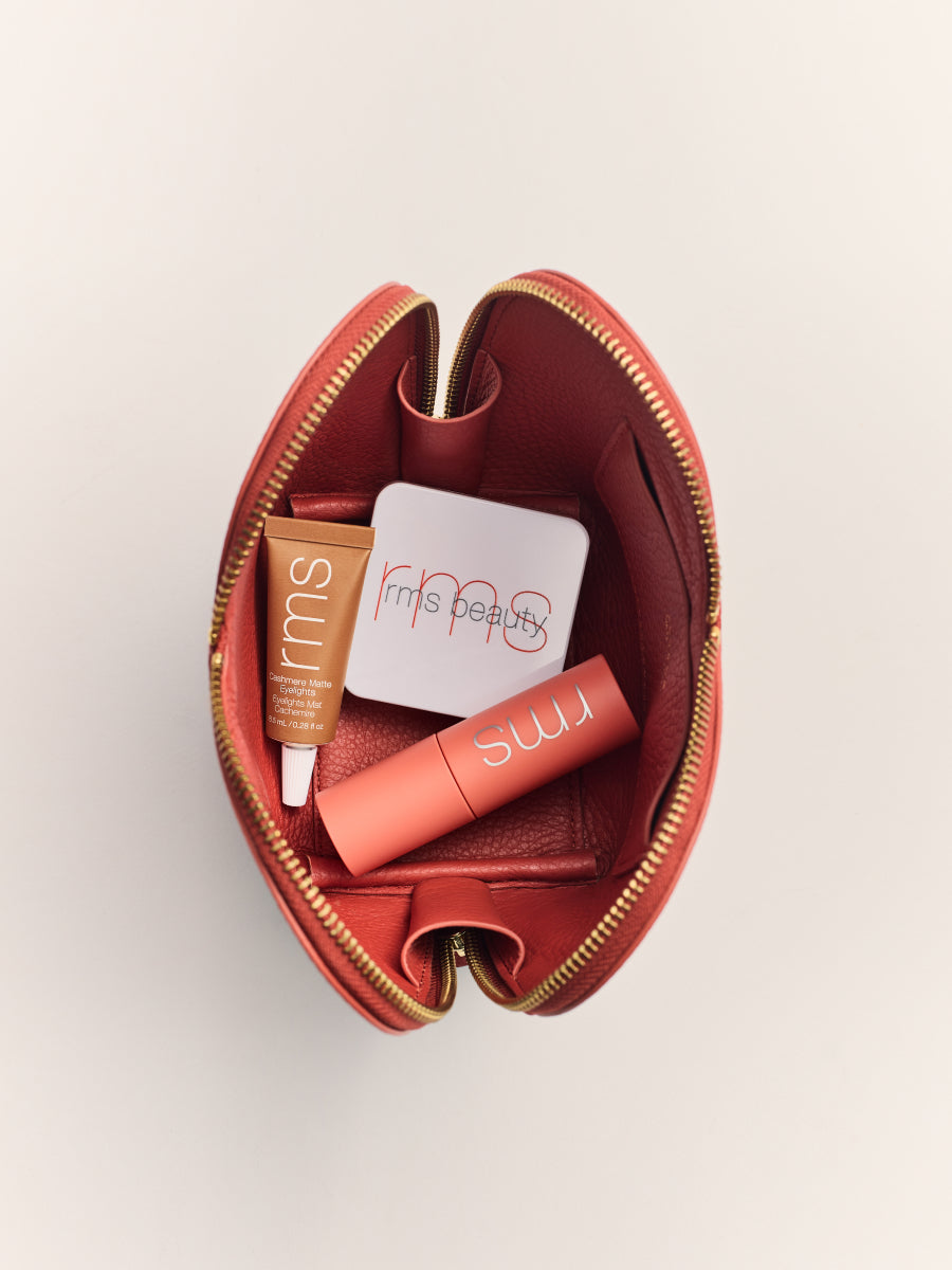 Open makeup pouch with cosmetics inside.