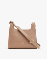 Handbag with adjustable strap and metal ring detail