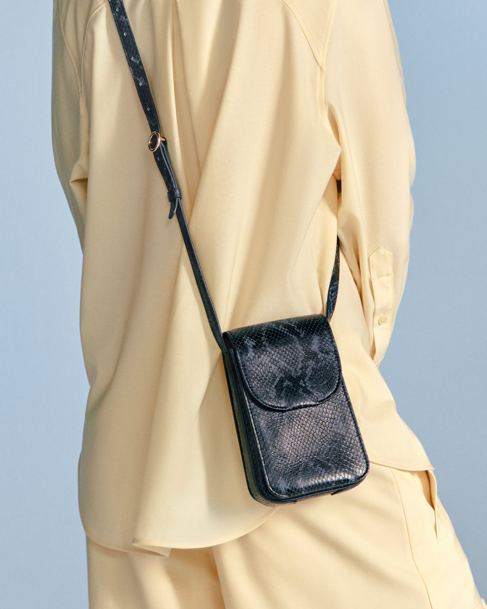 Person wearing a blouse with a shoulder bag