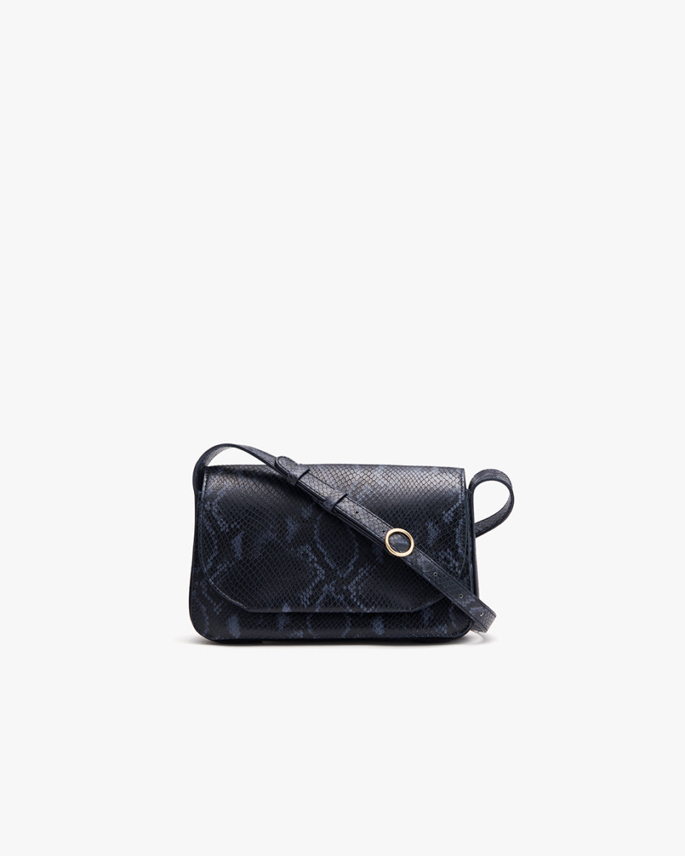 Small shoulder bag with a flap closure and strap on a plain background.