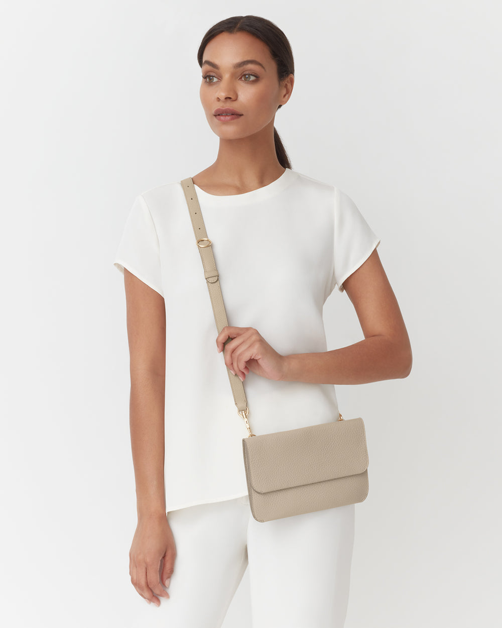 Woman standing with a shoulder bag