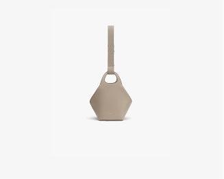 Geometric handheld bag with strap, isolated on plain background.