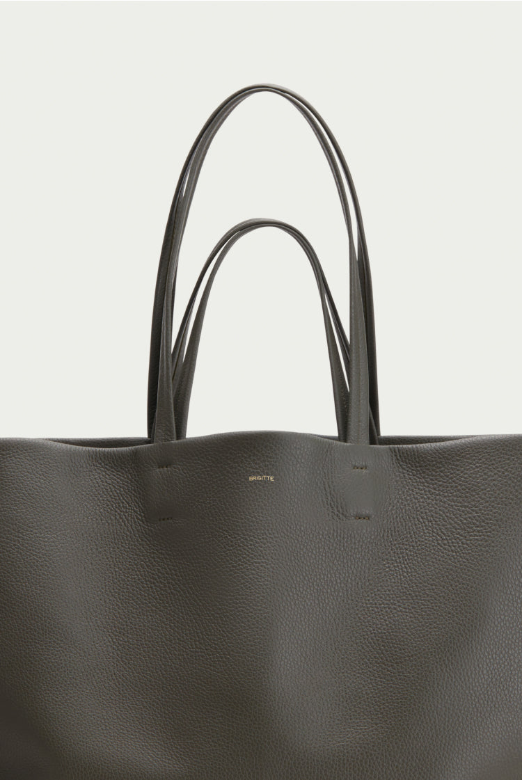 Close-up of a plain tote bag with two handles.