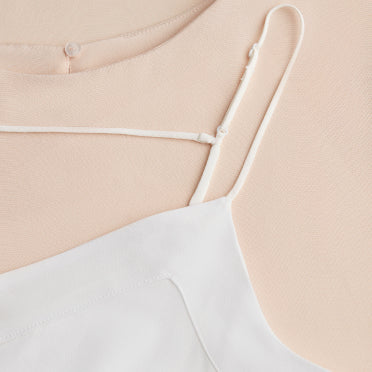 Close-up of a shirt under another with visible straps