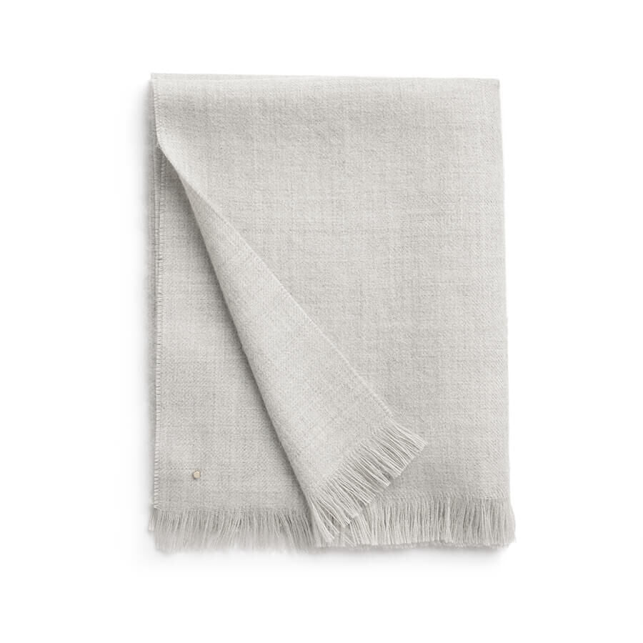 Folded fabric with fringe on one edge