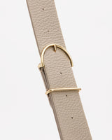 Close-up of a textured belt with a buckle.