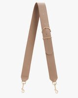 Adjustable strap with buckle and metal clasps hanging against a plain background.