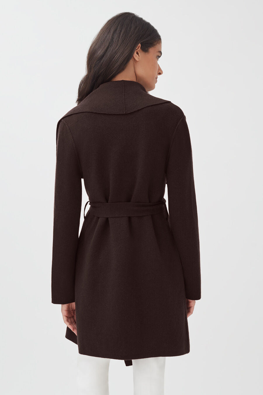 Woman seen from behind wearing a belted coat