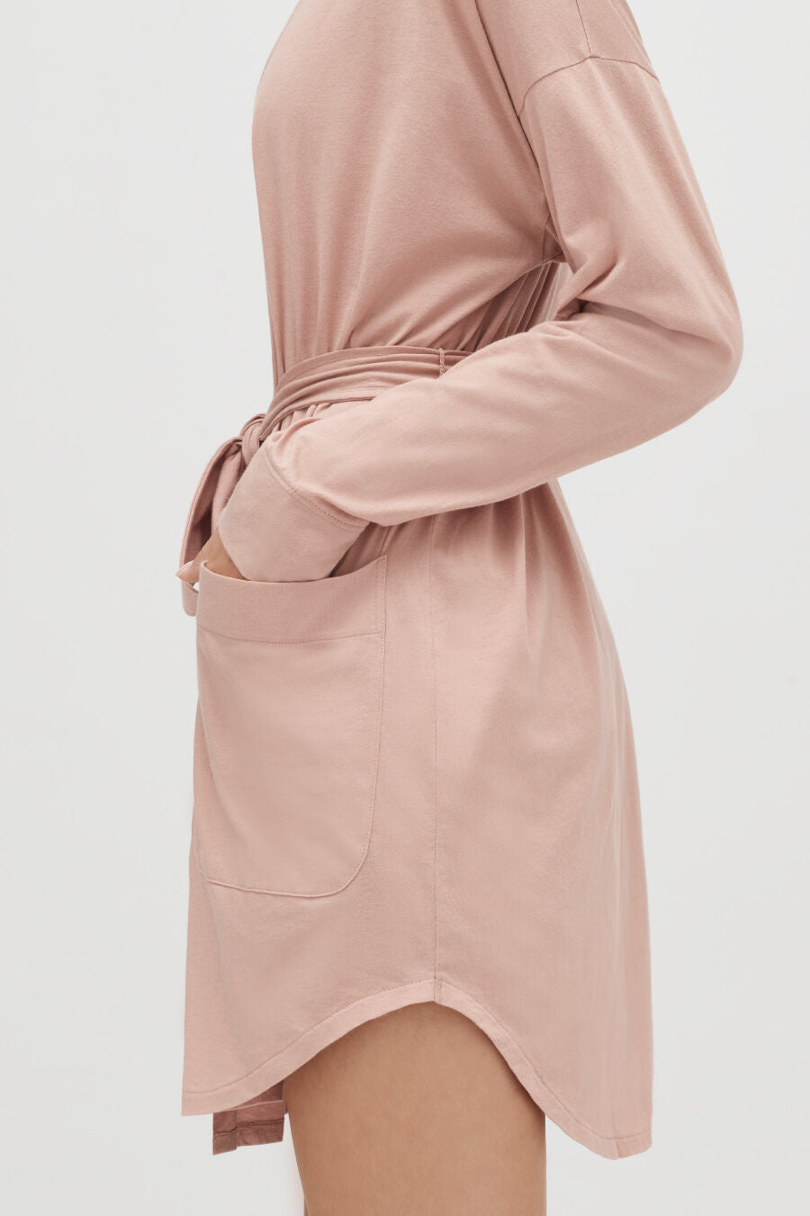 Person with hands tied at the back with a fabric belt.