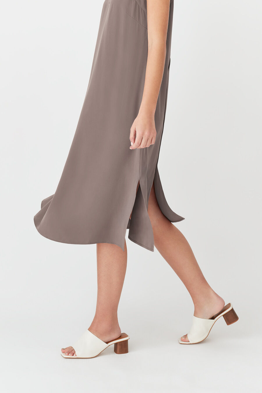 Person walking in a dress and open-toe heels.