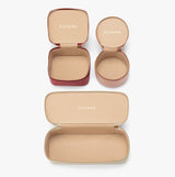 Four open cases of varying shapes with branding on the lids.