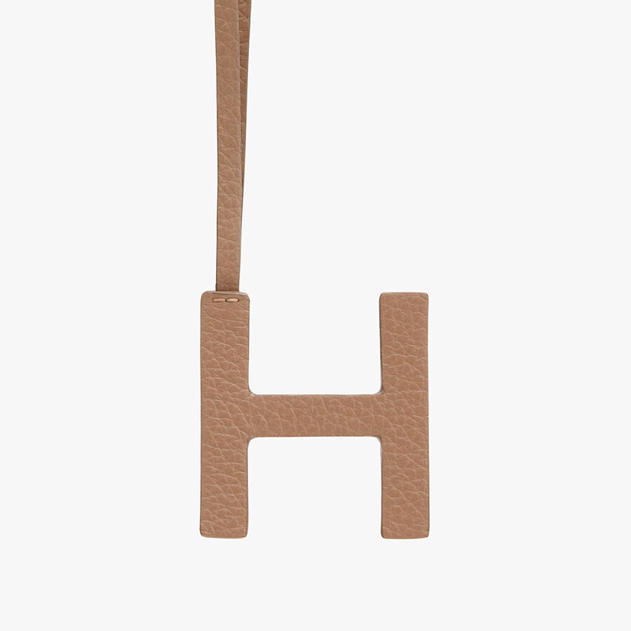 Letter H hanging from a strap