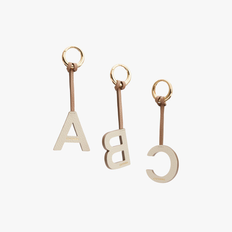 Three keychains with letters A, B, and C attached.