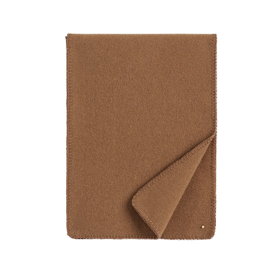 Closed fabric notebook with one corner folded open.