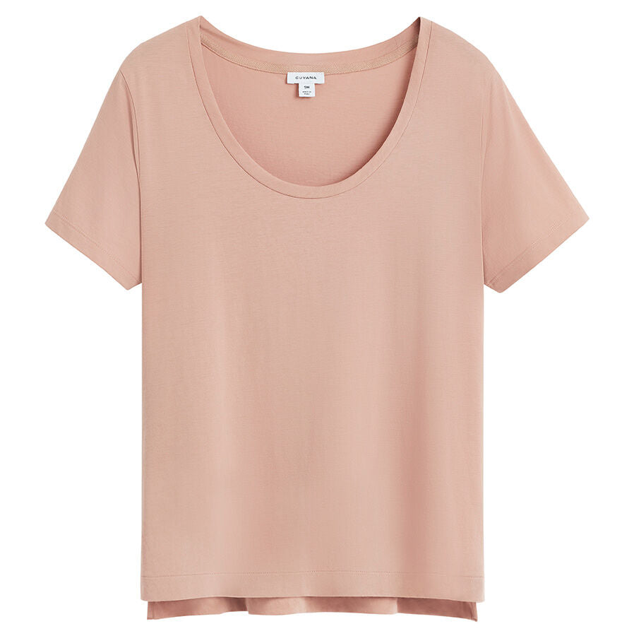 T-shirt with short sleeves and scoop neckline on plain background.