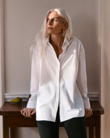 Woman standing by a table looking to the side